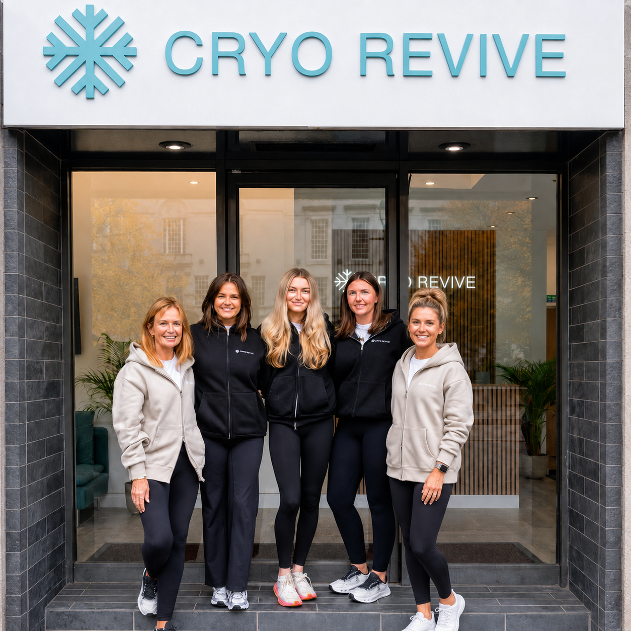 The Cryo Revive therapist team outside the studio entrance under the Cryo Revive sign